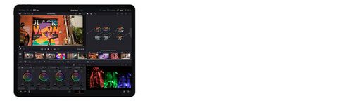 DaVinci Resolve on iPad in colour grading mode, with a street art mural in the viewer, colour wheels, a node graph and parade scopes